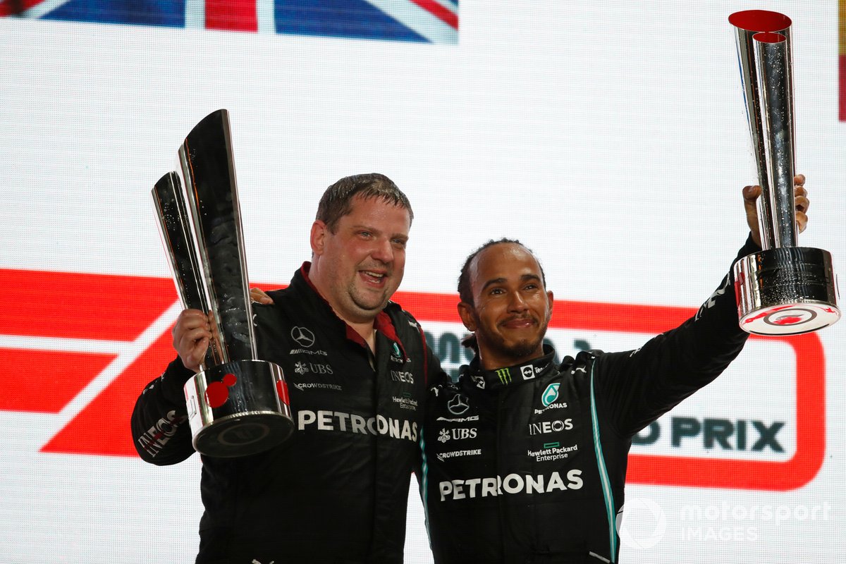 The Mercedes trophy delegate and Lewis Hamilton, Mercedes, 1st position, on the podium with the trophies