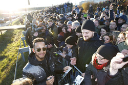 Lewis Hamilton signs autographs