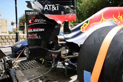 The damaged Red Bull Racing RB12 of Daniel Ricciardo, is recovered back to the pits on the back of a truck