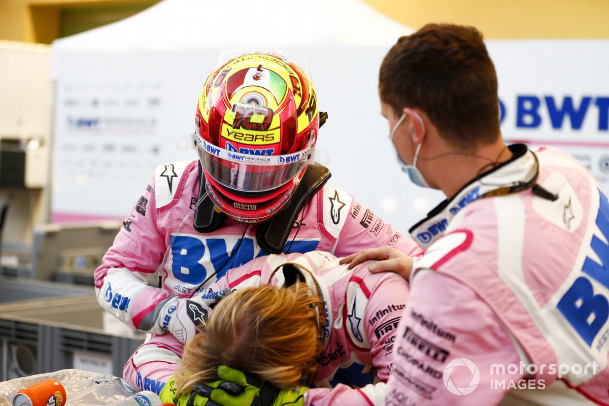 Sergio Perez, Racing Point, comiserates with his mechanics after retiring from the race
