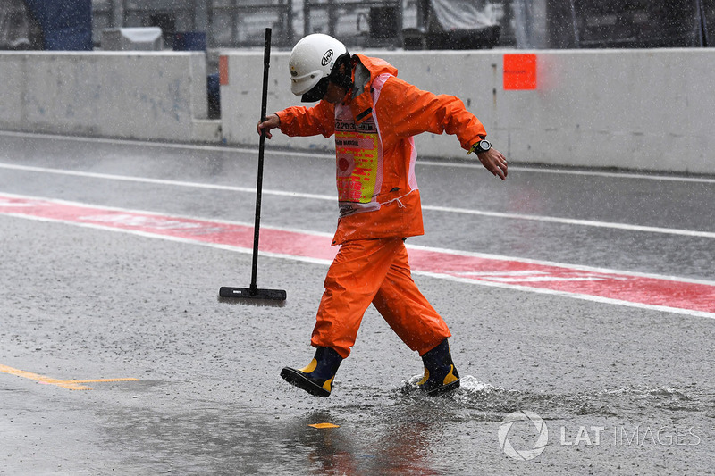 Marshals and flooded pit lane