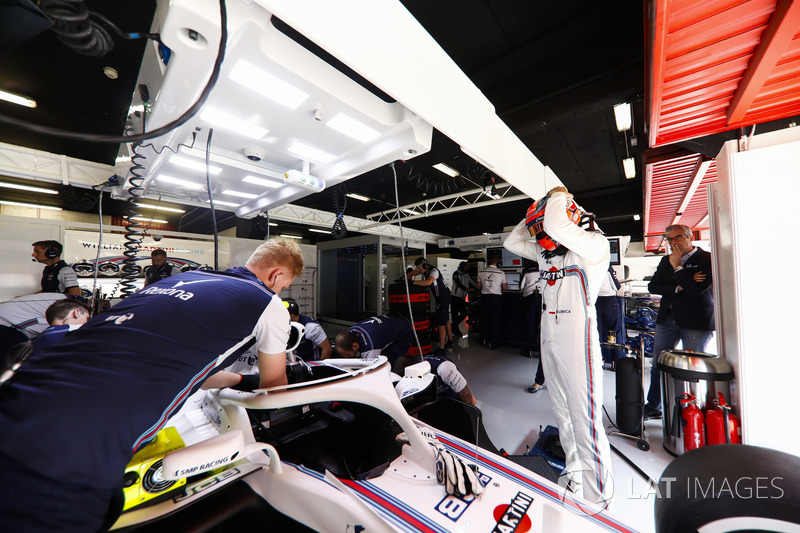 Robert Kubica, Williams Martini Racing, prepares to enter his cockpit