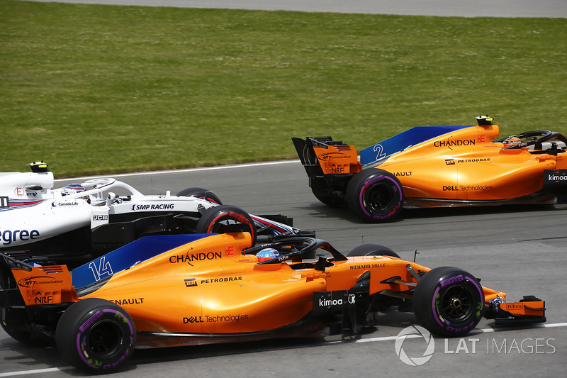 Stoffel Vandoorne, McLaren MCL33, leads Fernando Alonso, McLaren MCL33, and Sergey Sirotkin, William