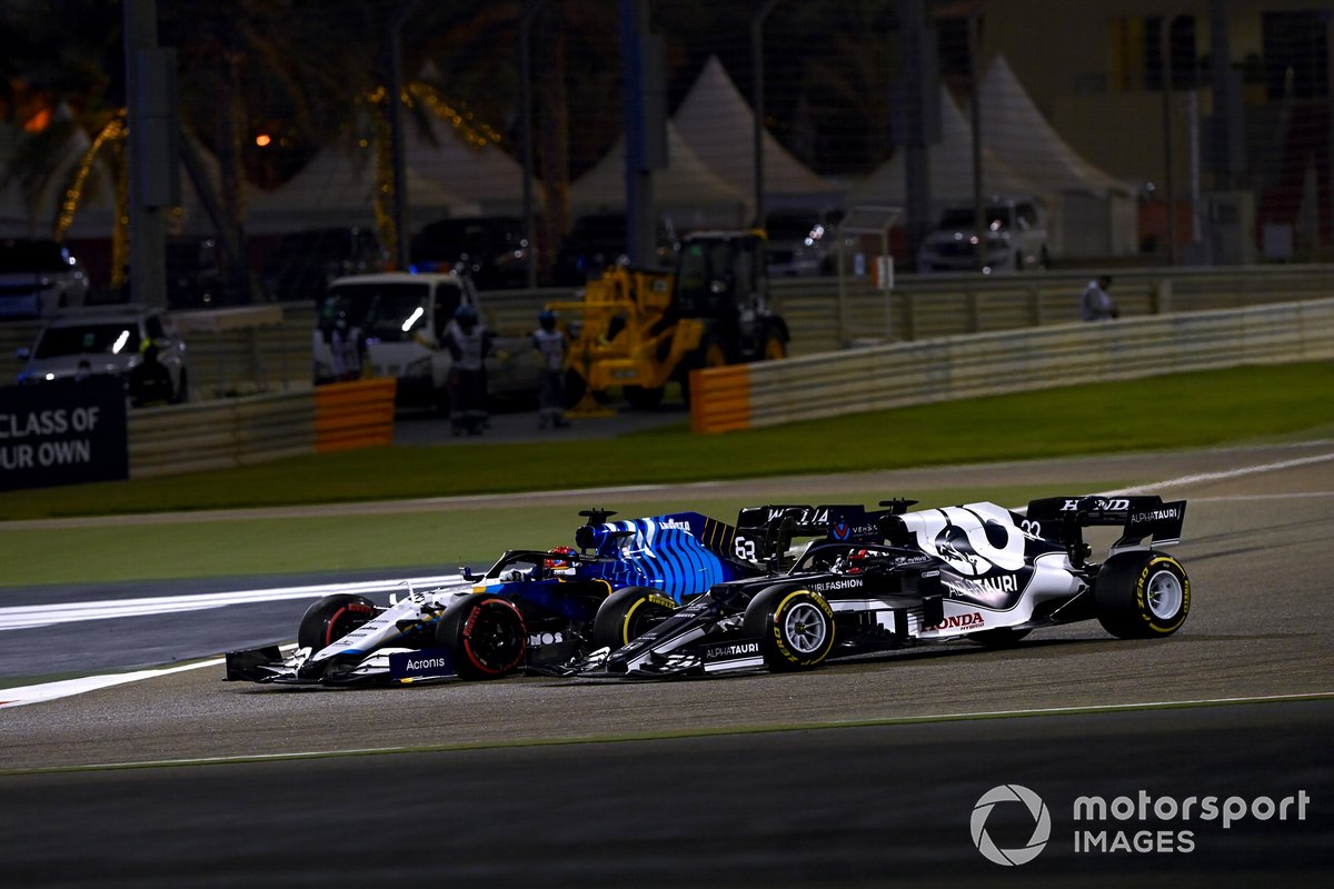 George Russell, Williams FW43B, and Yuki Tsunoda, AlphaTauri AT02, go off track whilst battling for position