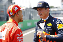 Pole winner Sebastian Vettel, Ferrari, talks to second place Max Verstappen, Red Bull Racing
