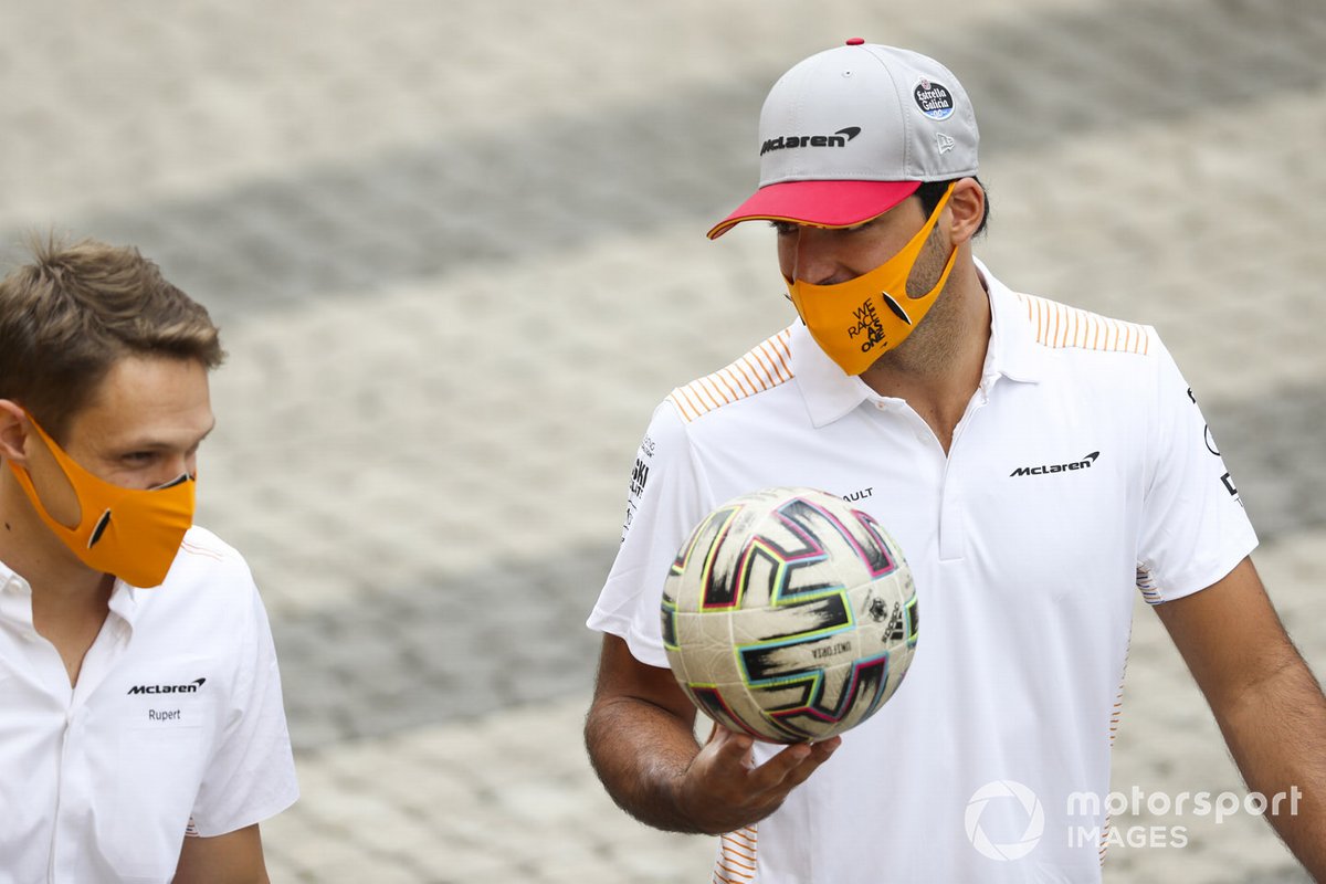 Carlos Sainz Jr., McLaren in the paddock with a football