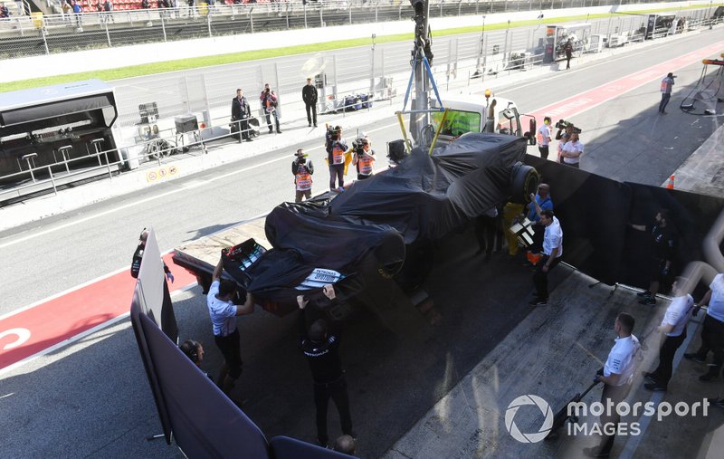 Lewis Hamilton's Mercedes F1 W11 is returned to the pits