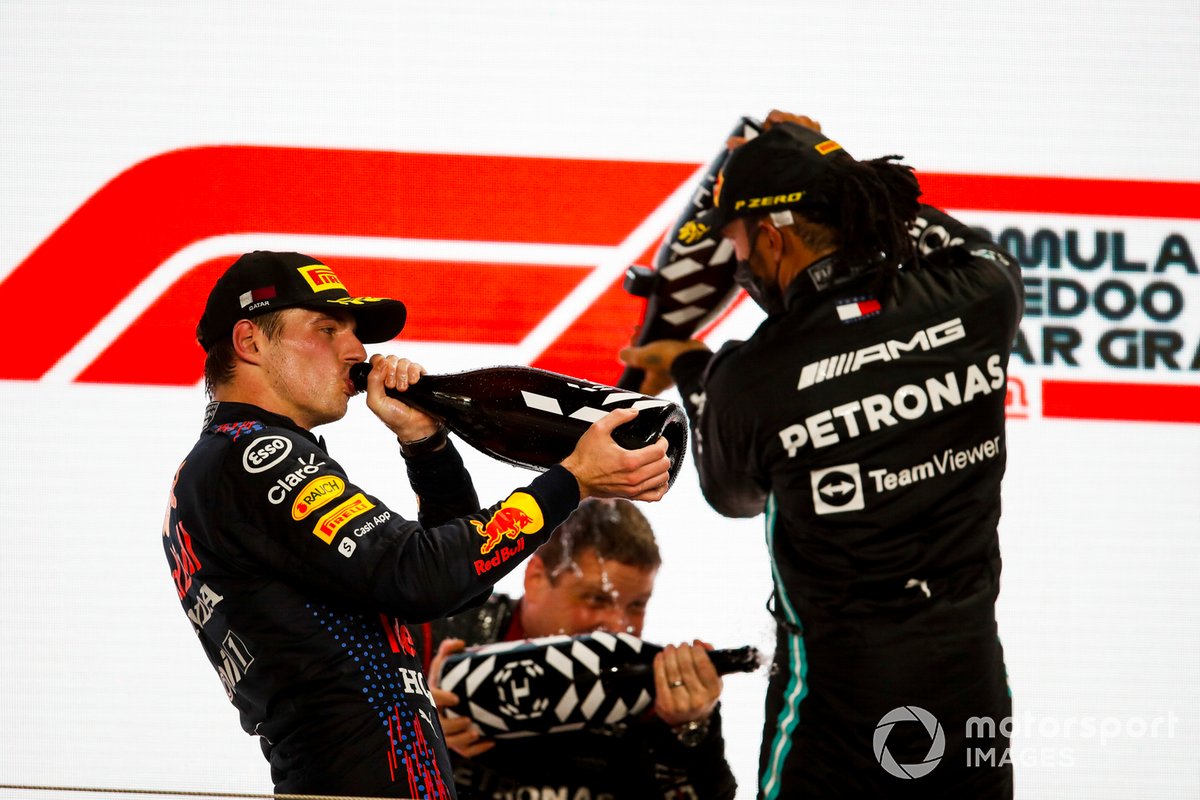 Max Verstappen, Red Bull Racing, 2nd position, and Lewis Hamilton, Mercedes, 1st position, celebrate with Rose Water