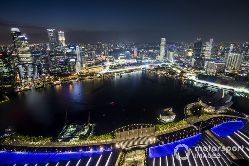 A scenic view of the Singapore skyline at night and the Marina Bay Formula 1 street circuit