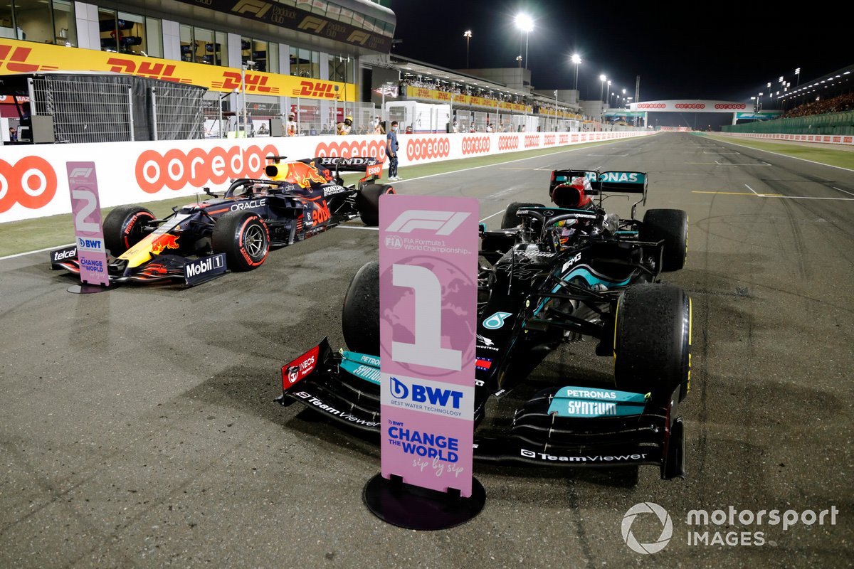 Lewis Hamilton, Mercedes W12, 1st position, and Max Verstappen, Red Bull Racing RB16B, 2nd position, arrive in Parc Ferme