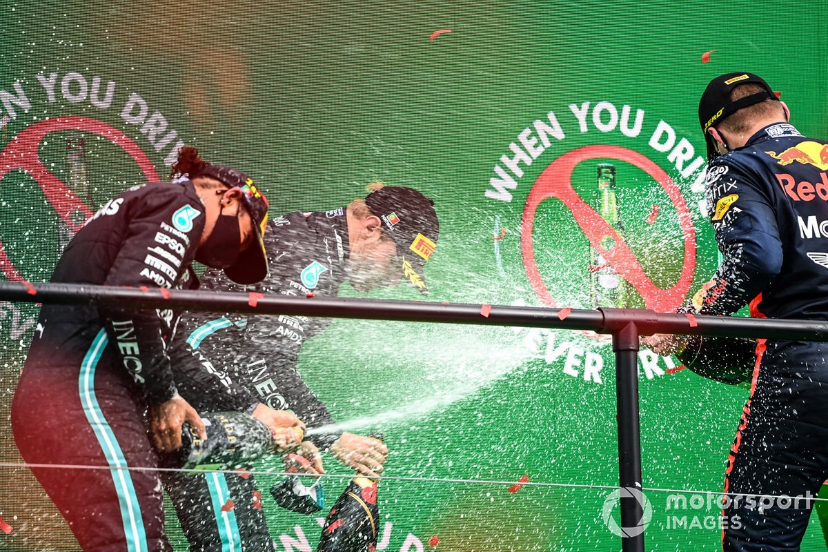 Lewis Hamilton, Mercedes-AMG F1, 1st position, Valtteri Bottas, Mercedes-AMG F1, 2nd position, and Max Verstappen, Red Bull Racing, 3rd position, celebrate with Champagne on the podium