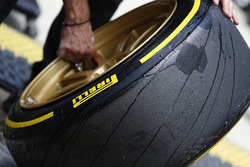 A Lotus team member works on the 18 inch wheels