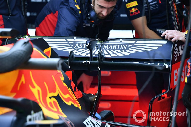 Mechanics work on the rear of a Red Bull Racing RB16