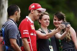 Sebastian Vettel, Ferrari, poses for a photo with a fans