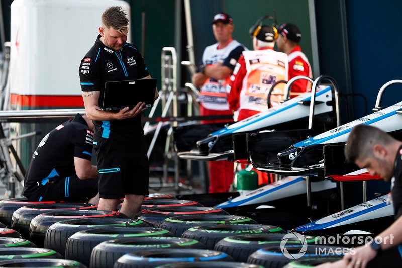 The Williams team prepare tyres in the paddock