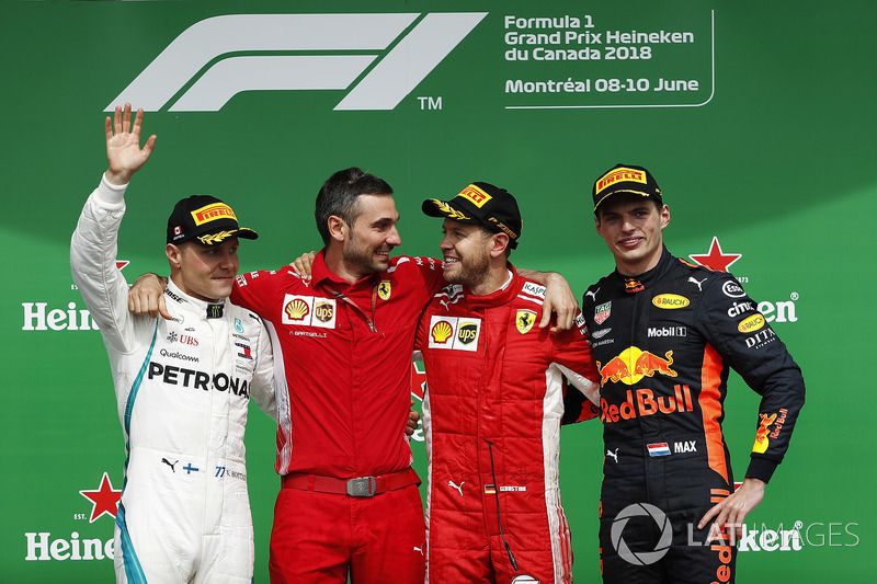 Sebastian Vettel, Ferrari, festeggia la vittoria sul podio con Valtteri Bottas, Mercedes AMG F1 e Max Verstappen, Red Bull Racing