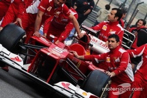 Ferrari F2012 pushed to scrutineering by mechanics