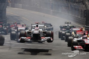 Kamui Kobayashi, Sauber flies through the air at the start of the race as he crashed with Romain Grosjean, Lotus F1