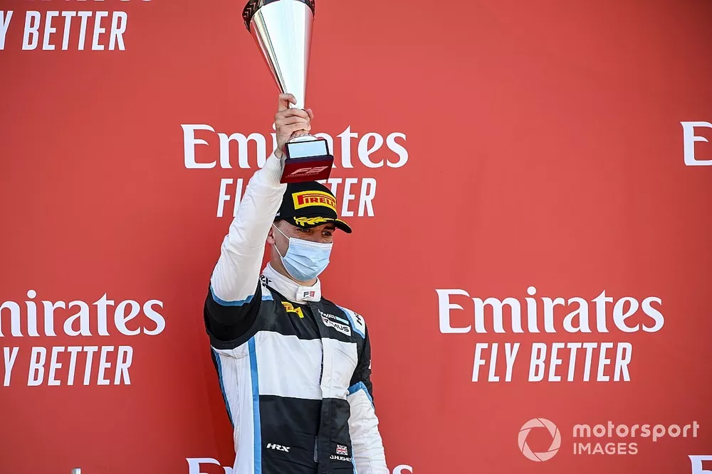 Jake Hughes, HWA Racelab on the podium with the trophy
