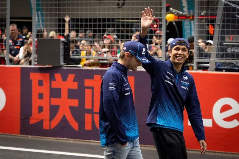 Logan Sargeant, Williams Racing, Alex Albon, Williams Racing, wave at the crowds during the driver presentation