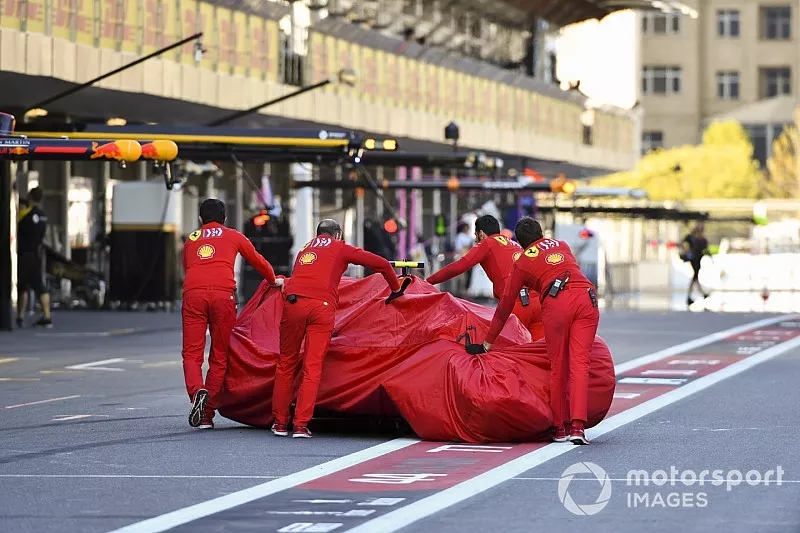 Crashed car of Charles Leclerc, Ferrari SF90 pushed down the pit lane by Ferrari mechanics