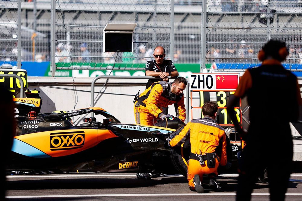 Lando Norris, McLaren MCL60, in the pit lane with mechanics