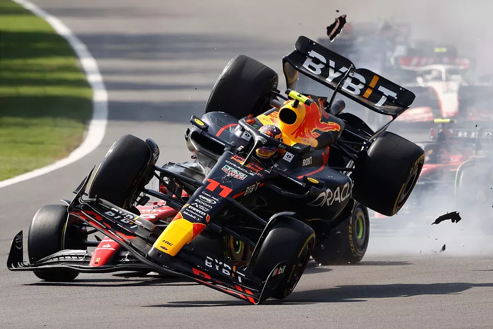 Charles Leclerc, Ferrari SF-23, Sergio Perez, Red Bull Racing RB19, make contact at the start causing the Mexican to crash out