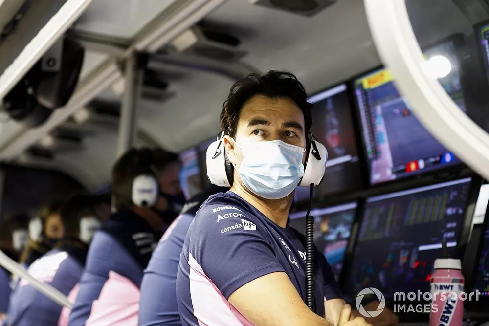 Sergio Perez, Racing Point, on the pit wall after retiring from the race