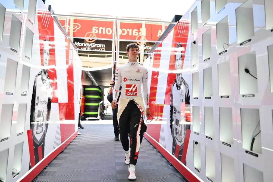 Oliver Bearman, Haas F1 Team, walks down the garage walkway