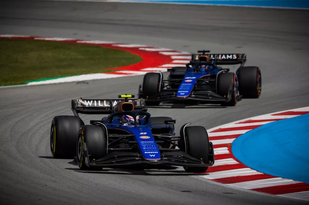 Logan Sargeant, Williams FW46, leads Alex Albon, Williams FW46