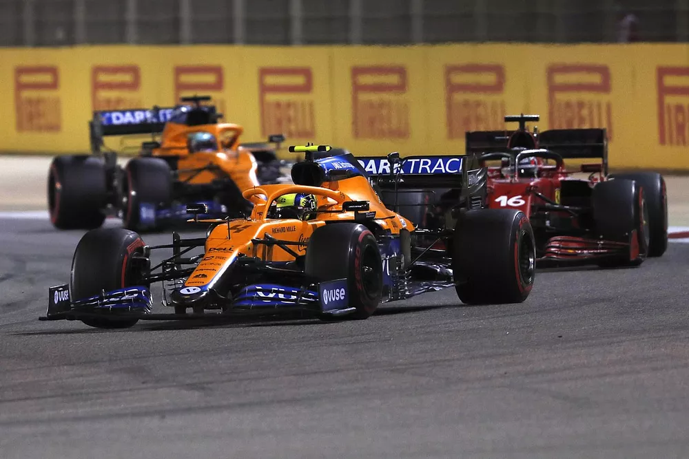 Lando Norris, McLaren MCL35M, Charles Leclerc, Ferrari SF21, and Daniel Ricciardo, McLaren MCL35M