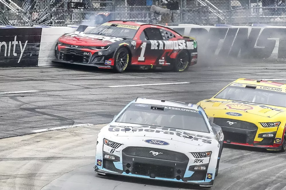 Ross Chastain, TrackHouse Racing, Moose Fraternity Chevrolet Camaro launches his car into the wall to speed around Turn 4 to pass Denny Hamlin, Joe Gibbs Racing, FedEx Freight Direct Toyota Camry
