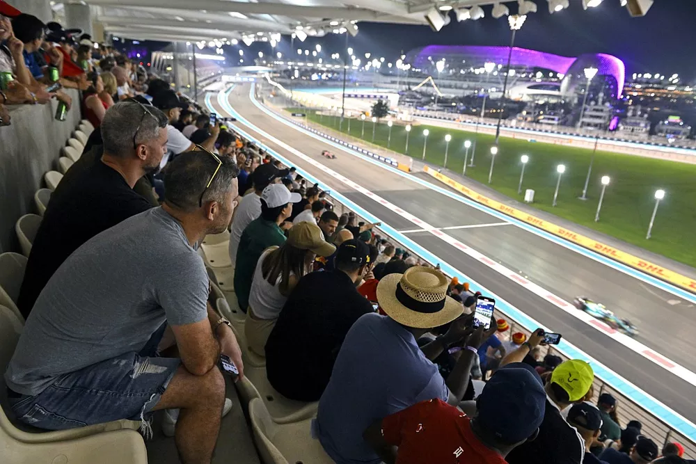 Fans watch as Sebastian Vettel, Aston Martin AMR22, passes