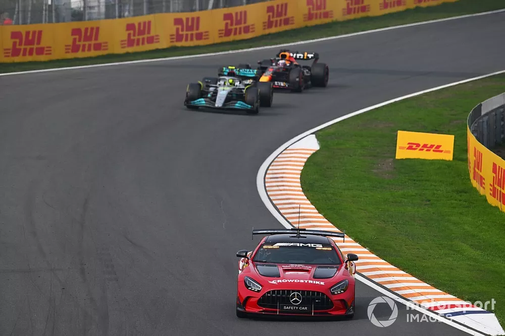 The FIA safety car leads Lewis Hamilton, Mercedes W13 and Max Verstappen, Red Bull Racing RB18