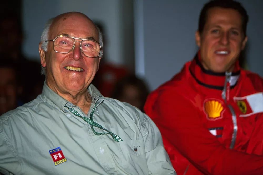Murray Walker, bows out of commentating whilst Michael Schumacher, Ferrari looks on
