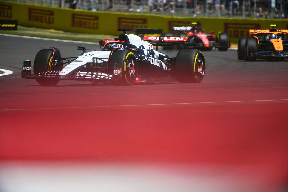 Nyck de Vries, AlphaTauri AT04, leads Lando Norris, McLaren MCL60, and Carlos Sainz, Ferrari SF-23