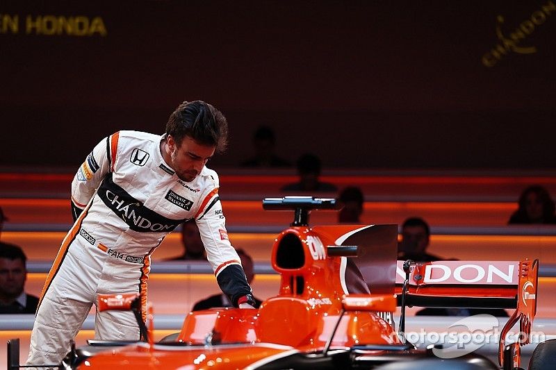 Fernando Alonso, McLaren, inspects the cockpit of the MCL32