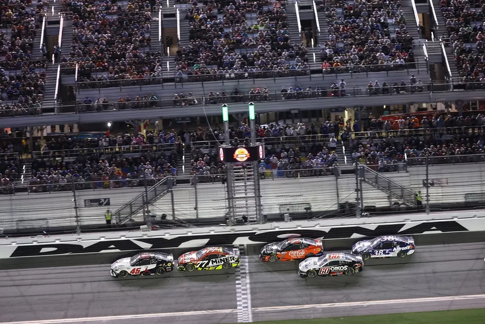 Tyler Reddick, No. 45 23XI Racing Toyota, and Carson Hocevar, No. 77 Spire Motorsports Chevrolet lead the field