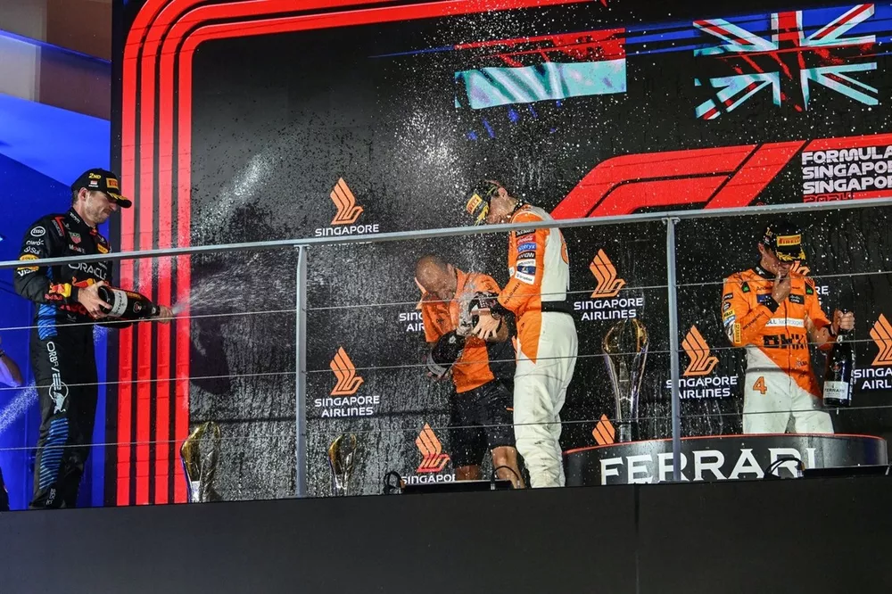Max Verstappen, Red Bull Racing, 2nd position, Lando Norris, McLaren F1 Team, 1st position, Oscar Piastri, McLaren F1 Team, 3rd position, spray Champagne on the podium