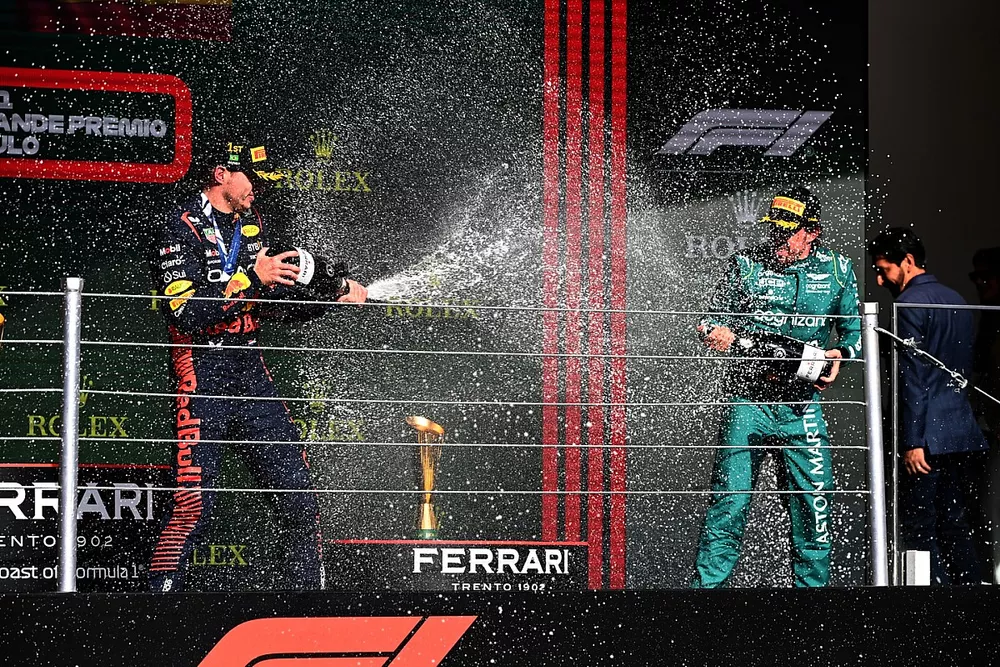 Max Verstappen, Red Bull Racing, 1st position, Fernando Alonso, Aston Martin F1 Team, 3rd position, spray Champagne on the podium