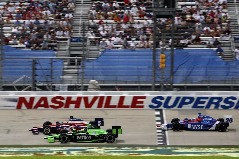 Scott Sharp and Marco Andretti lap Sarah Fishe