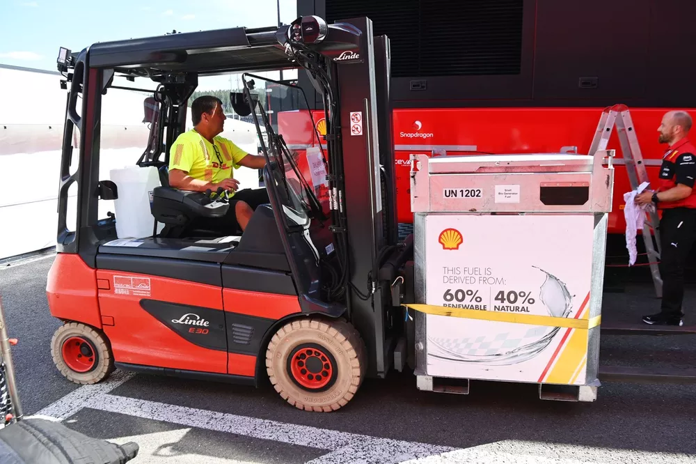 A forklift driver moves a pallet of fuel