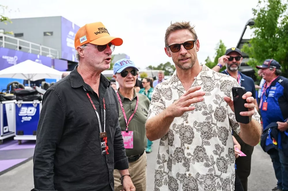 Eddie Irvine and Jenson Button talk in the Paddock 