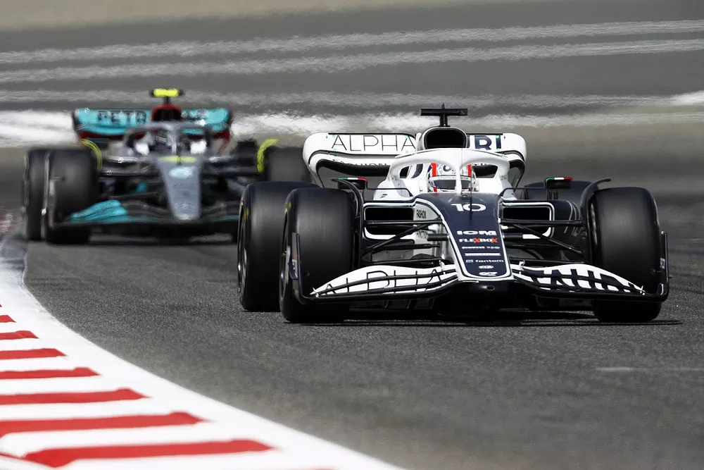 Pierre Gasly, AlphaTauri AT03, leads Lewis Hamilton, Mercedes W13