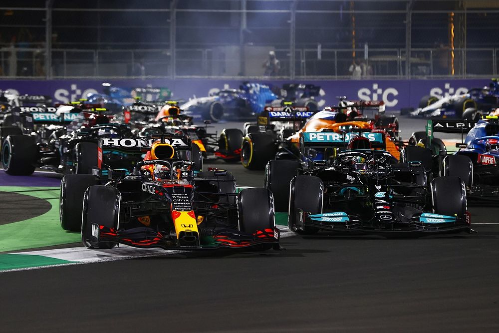 Max Verstappen, Red Bull Racing RB16B, runs off the track while battling with Lewis Hamilton, Mercedes W12 at the restart