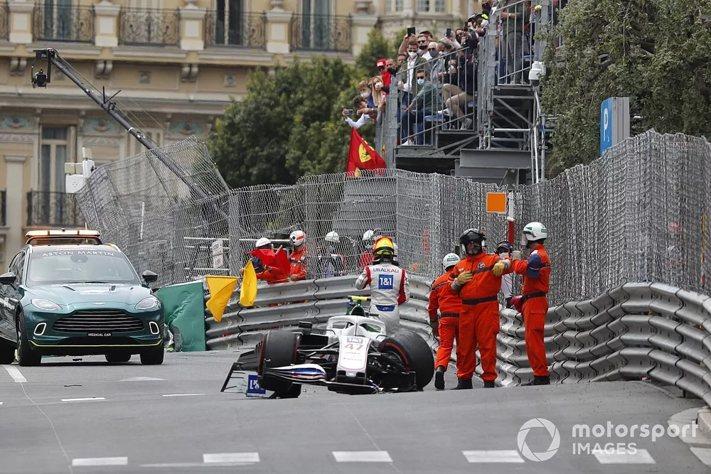 Marshals assist Mick Schumacher, Haas VF-21, after his crash in FP3