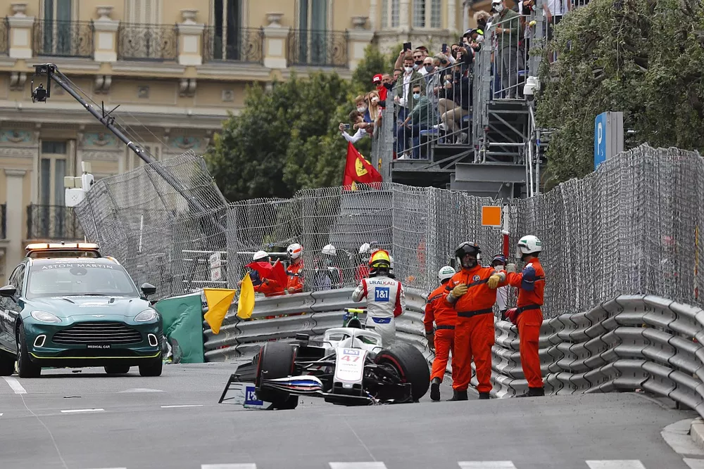 Marshals assist Mick Schumacher, Haas VF-21, after his crash in FP3