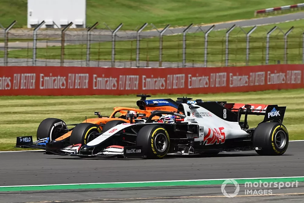 Romain Grosjean, Haas VF-20, battles with Carlos Sainz Jr., McLaren MCL35