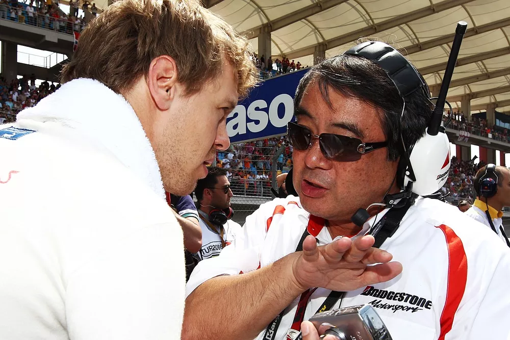 Sebastian Vettel (GER) Red Bull Racing talks with Hiroshi Yasukawa (JPN) Bridgestone Director of Motorsport on the grid. Formula One World Championship, Rd 7, Turkish Grand Prix, Race, Istanbul Park, Turkey, Sunday 30 May 2010.