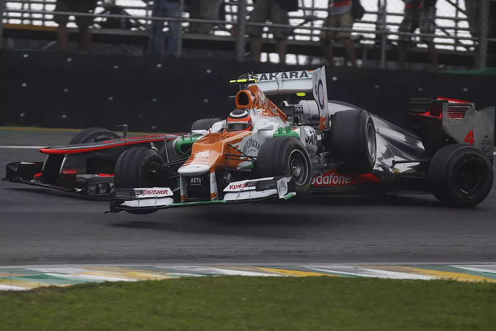 Nico Hulkenberg, Force India VJM05 Mercedes, slides into Lewis Hamilton, McLaren MP4-27 Mercedes, whilst attempting to pass for the lead